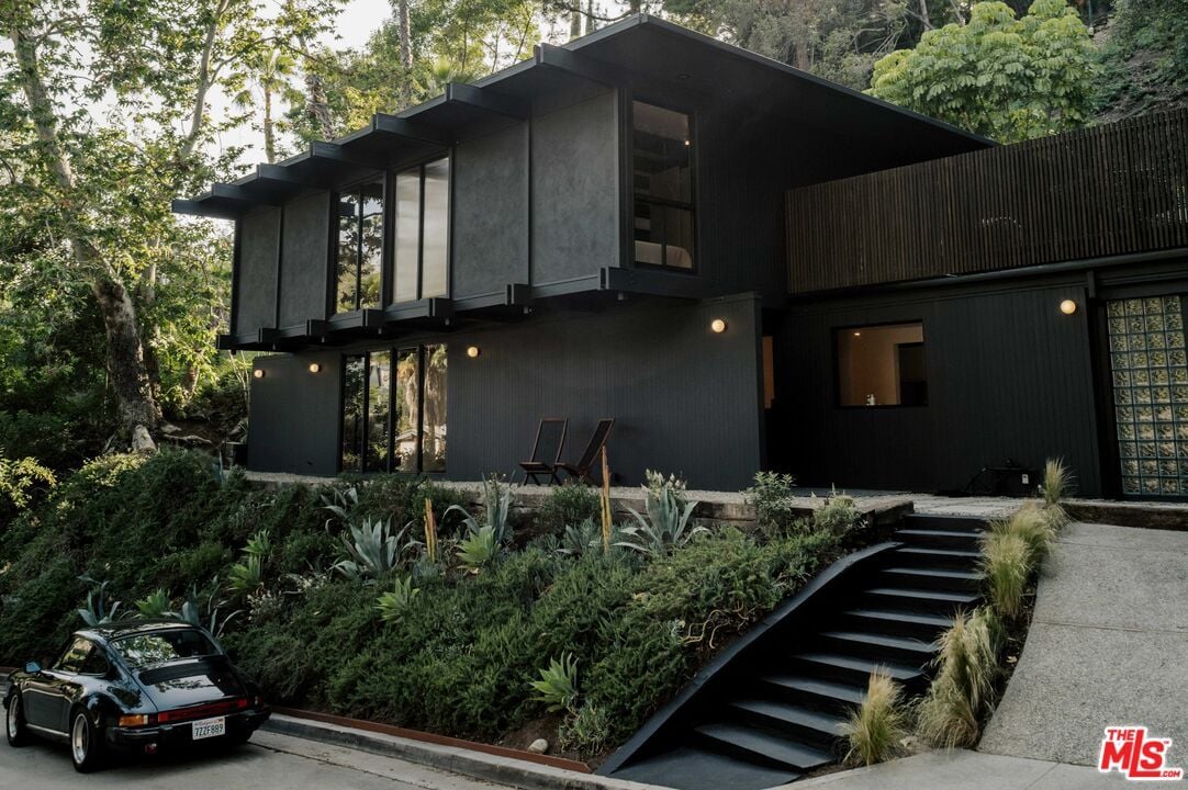 This $2.8M L.A. Midcentury Has an Ink-Black Facade and Bright-White Interiors