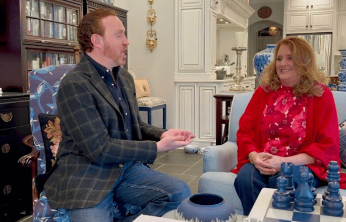 Kimberly Spears and a man talk during an interview in a furnished living room.