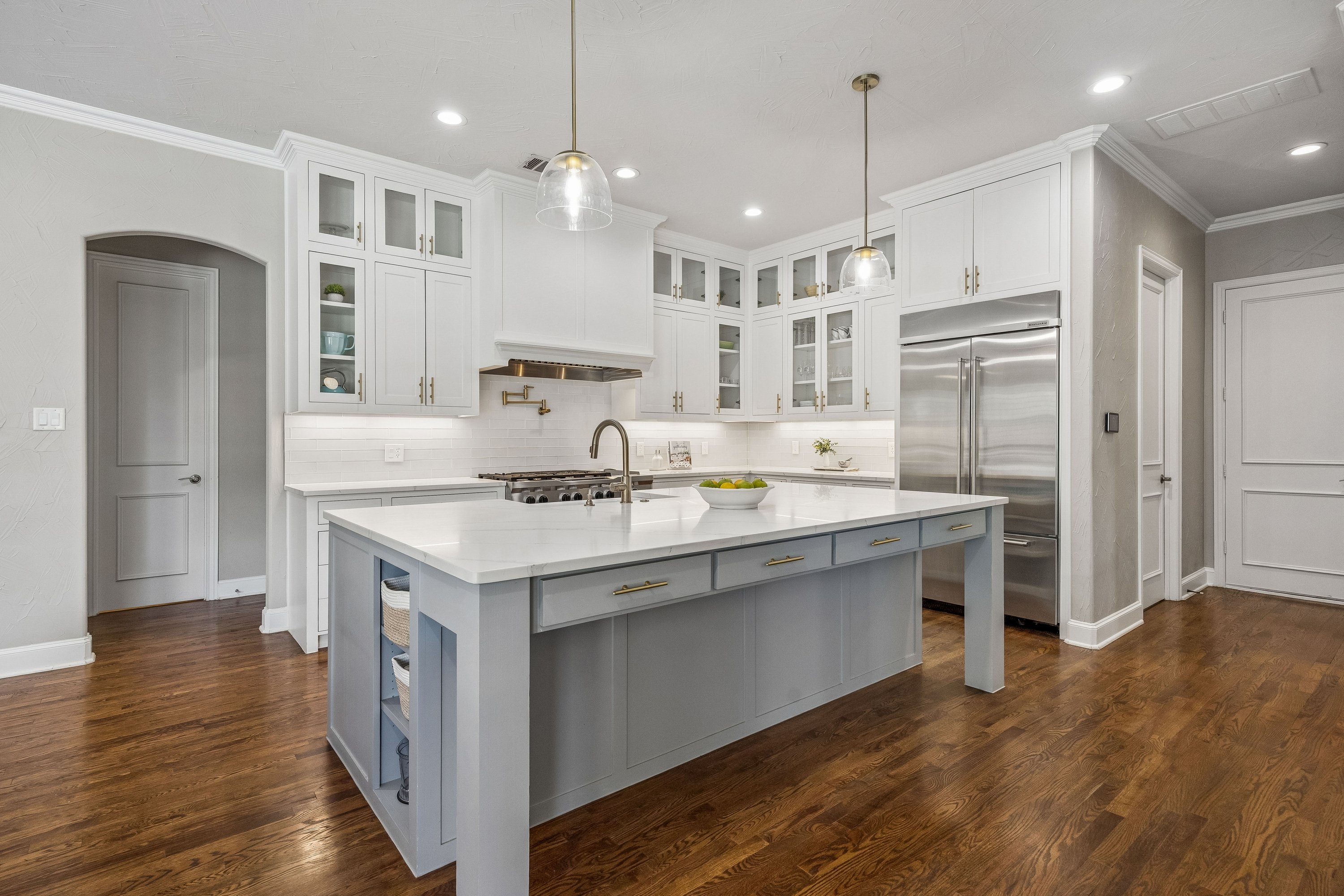 Renovated kitchen &mdash; KitchenAid commercial-grade range, farmhouse sink, oversized island