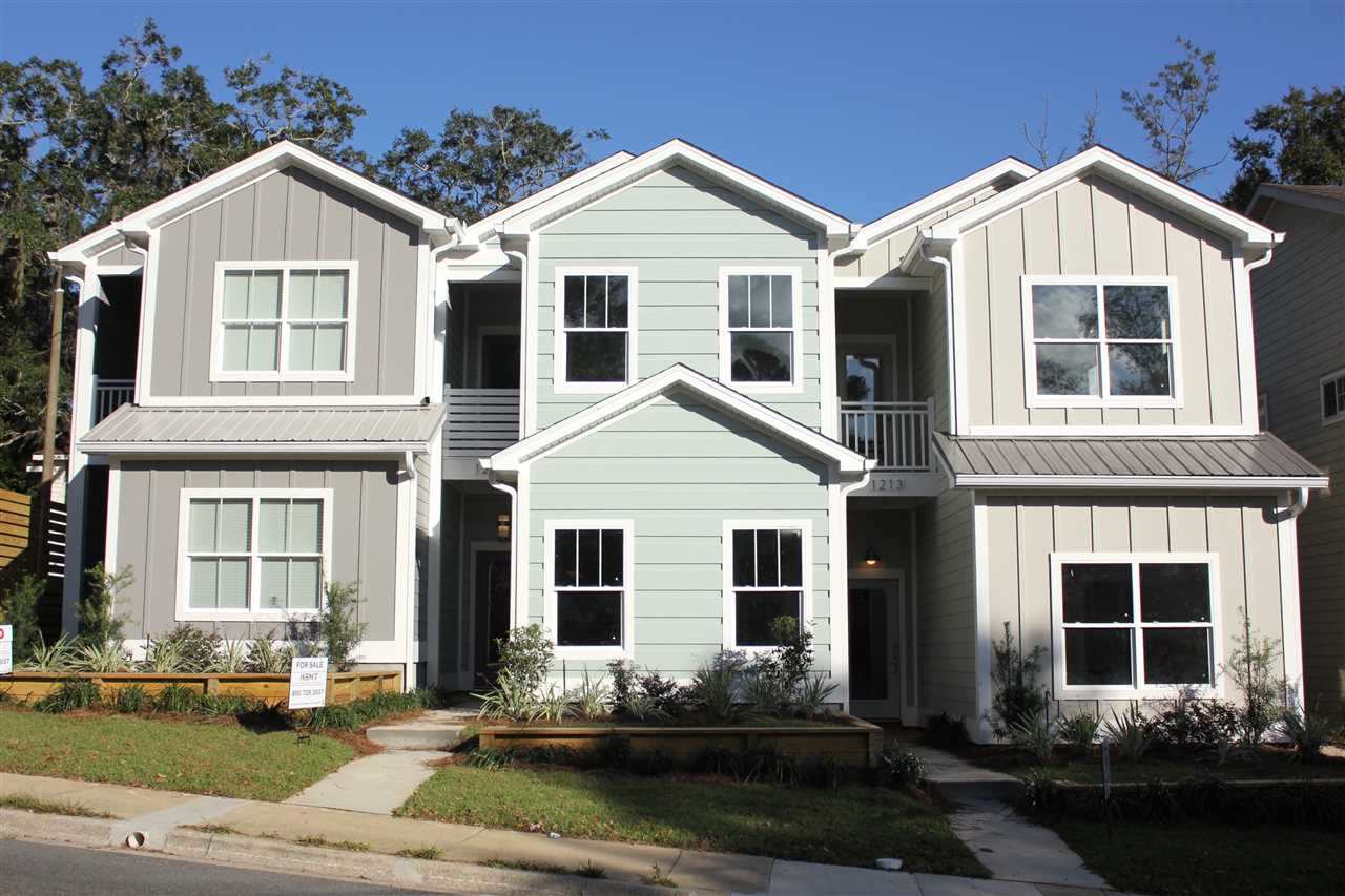 A row of three-story homes showcasing modern architecture and well-maintained facades.