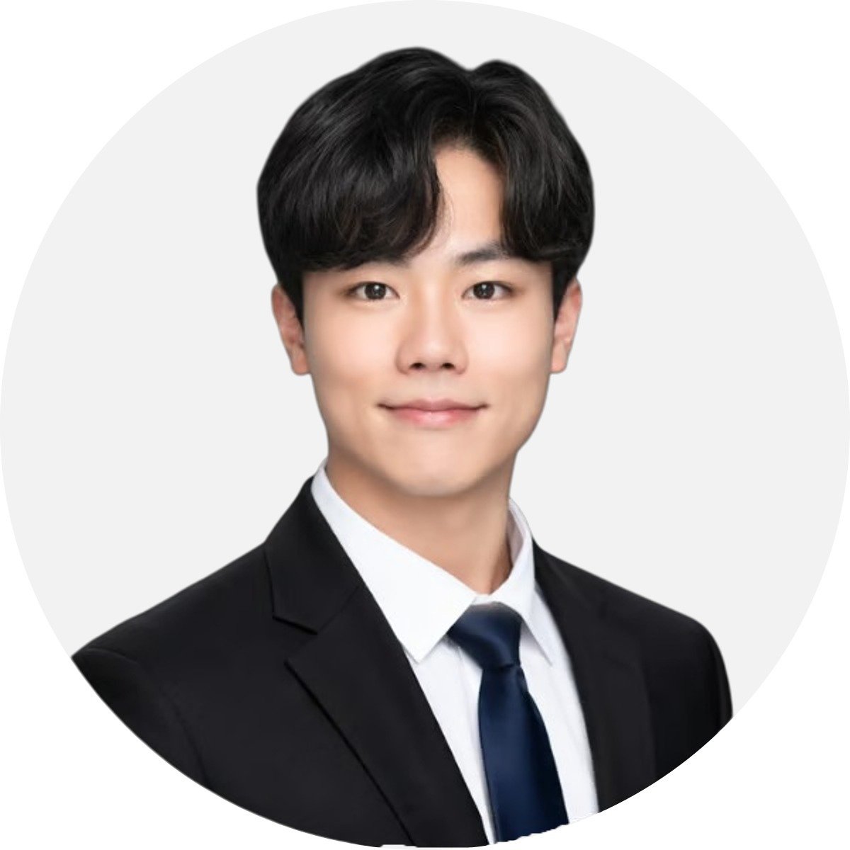 Jay Jeong wearing a black suit, white shirt, and navy tie.