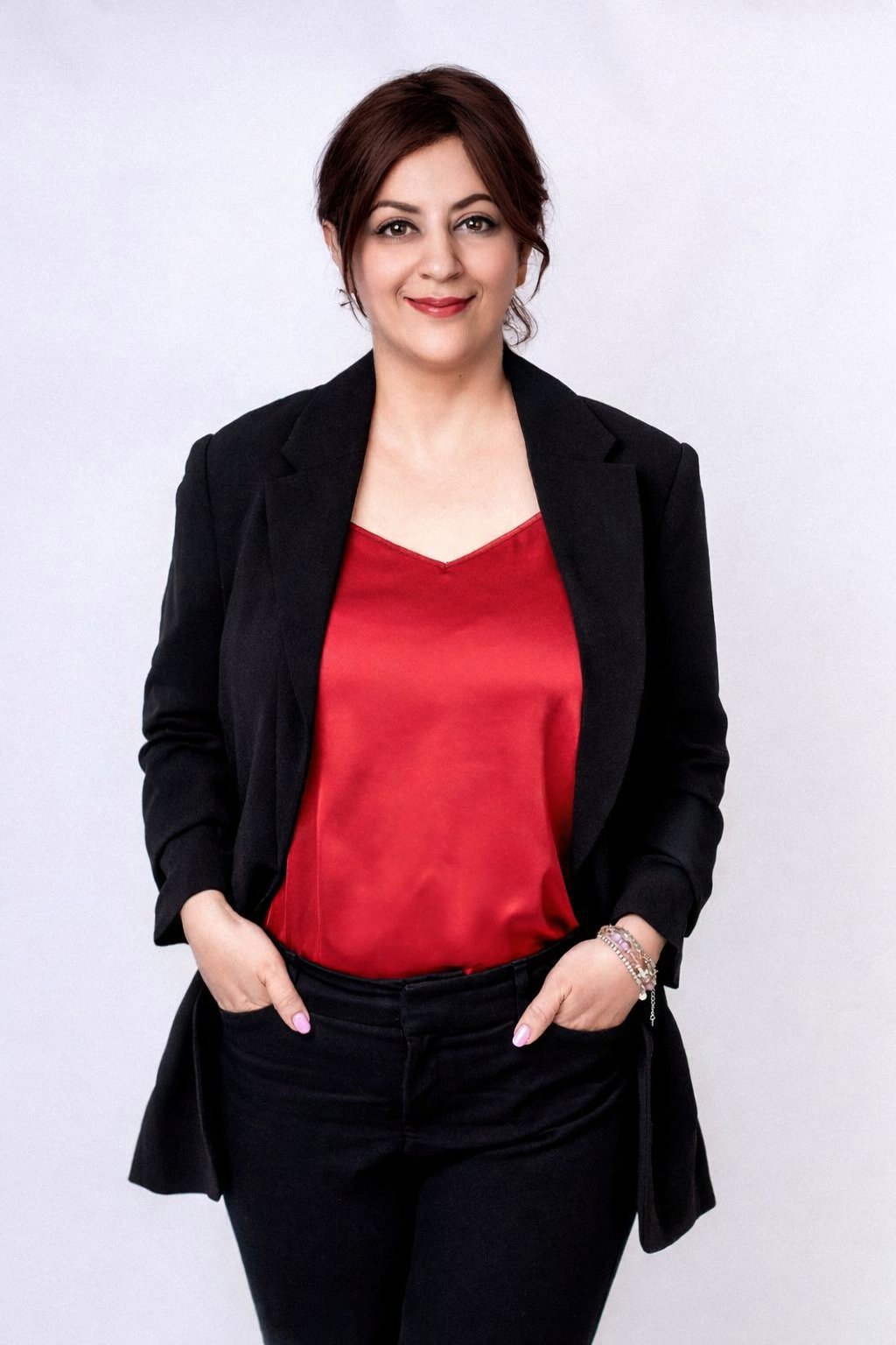 Panteha Safavi Momini in a black blazer and red top.