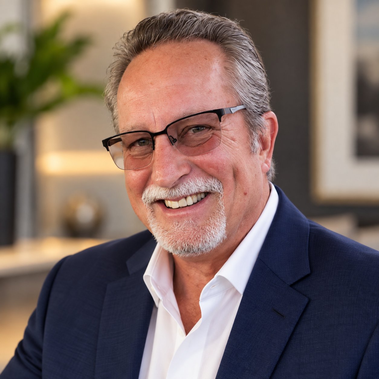 James M. Rixey smiling in glasses and a navy suit jacket.