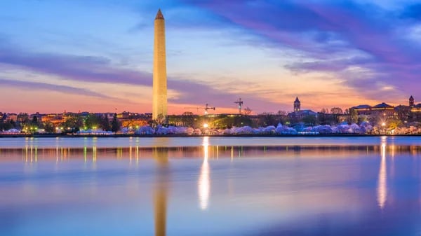 Washington Monument reflected in the Tidal Basin at dusk during cherry blossom season, Washington DC