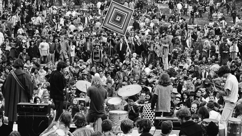 Groovy Gathering: During the 1967 Summer of Love, a massive crowd fills San Francisco’s Golden Gate Park, captivated by a guitarist in the foreground, strumming for the sea of hippie souls in this iconic black-and-white moment. Photo by Bob Klein, AP.