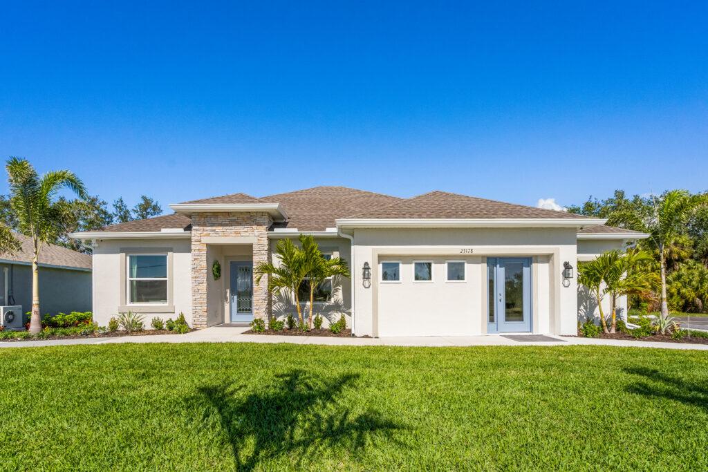 Modern single-family home with a landscaped front yard in Florida.