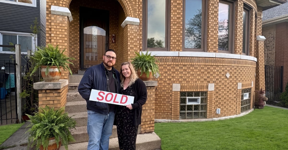 Buyers with sold sign at their new Portage Park Chicago home purchased by The Tully Team Realtors