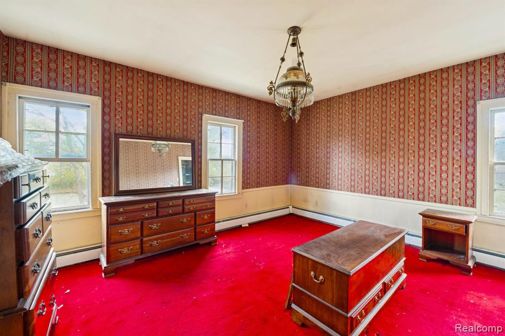 Primary bedroom in the 4-bedroom home for sale at 13278 9 Mile Road, South Lyon, MI,