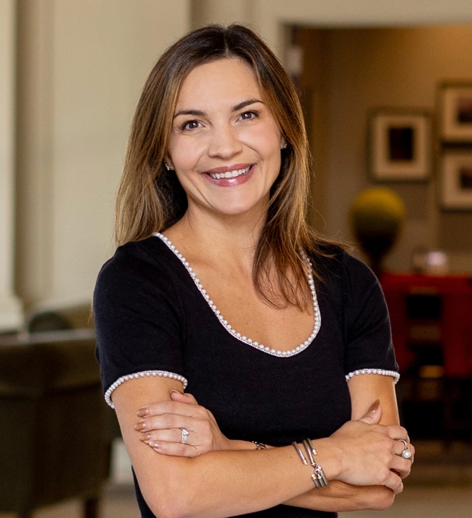 Ashleigh Shaner, real estate agent, smiling with her arms crossed.