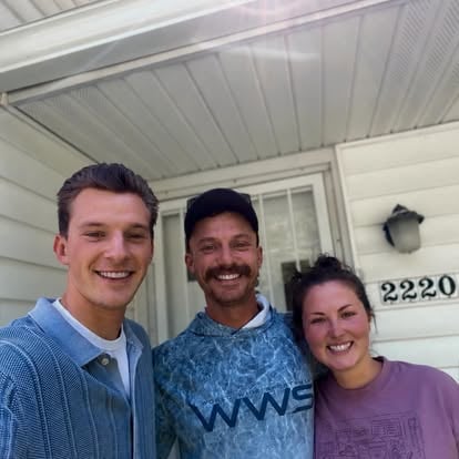 Aaron with clients on a front porch