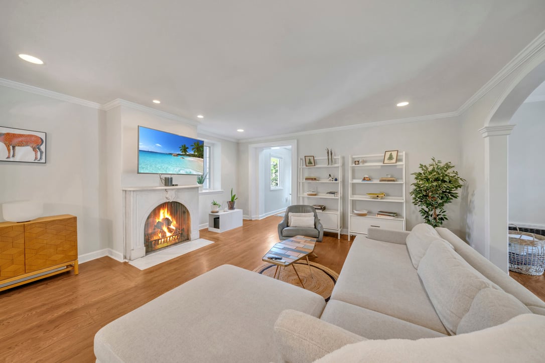 Old Tappan luxury living room featuring a lit fireplace and sectional sofa