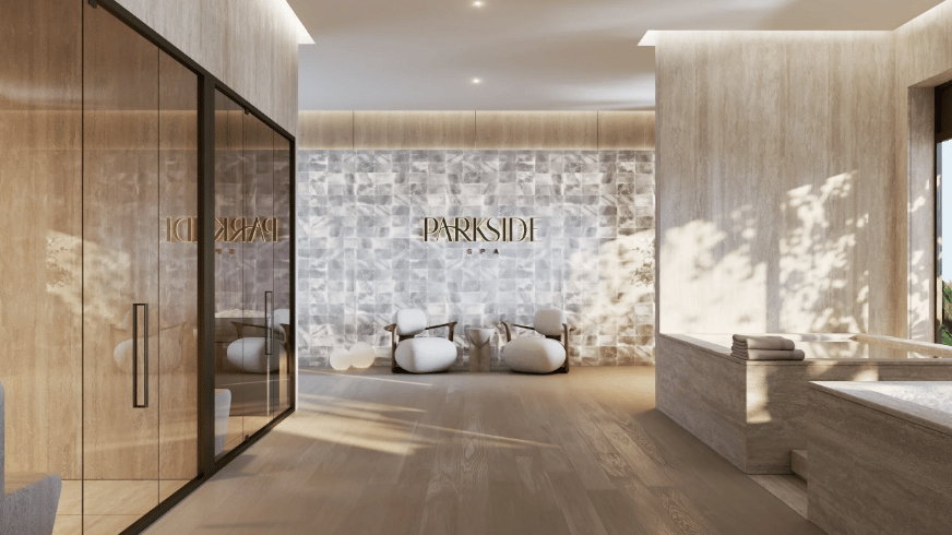 Parkside Spa interior with sculptural lounge chairs, a stone feature wall, and warm wood finishes.
