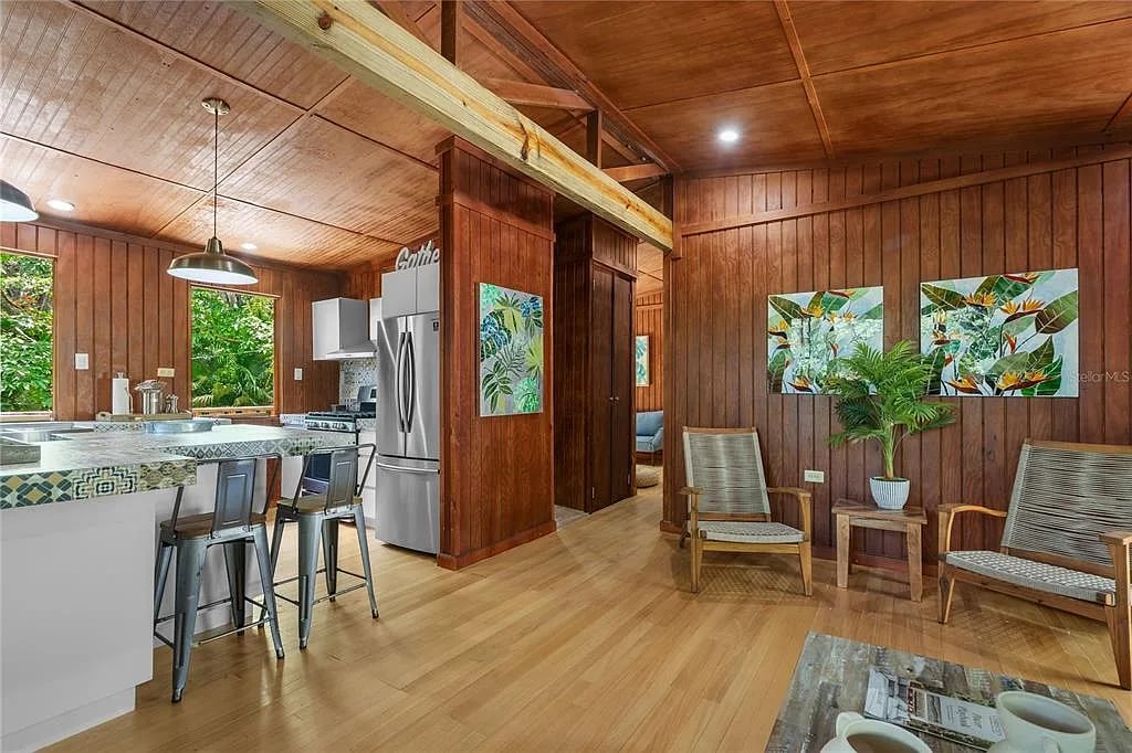 Wood-paneled living area with kitchen