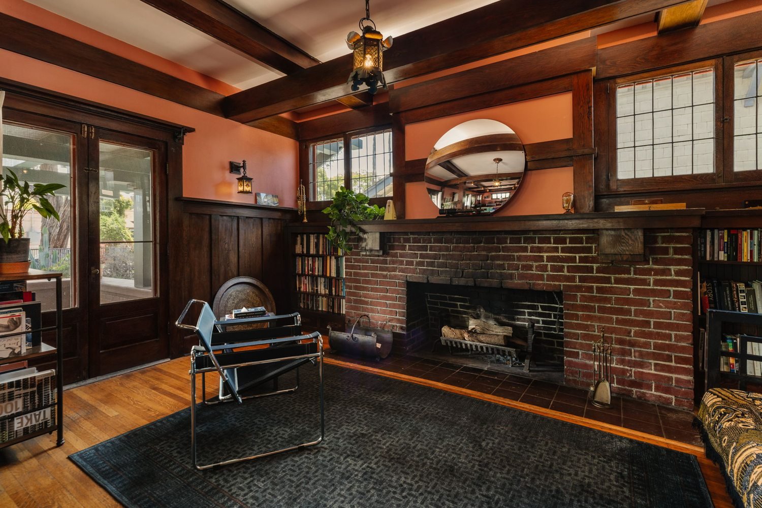 Sitting room in the A.C. Tobias Residence with a brick fireplace flanked by built-in wood bookshelves.
