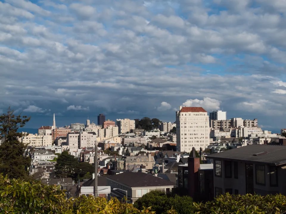 Panoramic city view from Pacific Heights San Francisco showing downtown skyline and mixed residential architecture