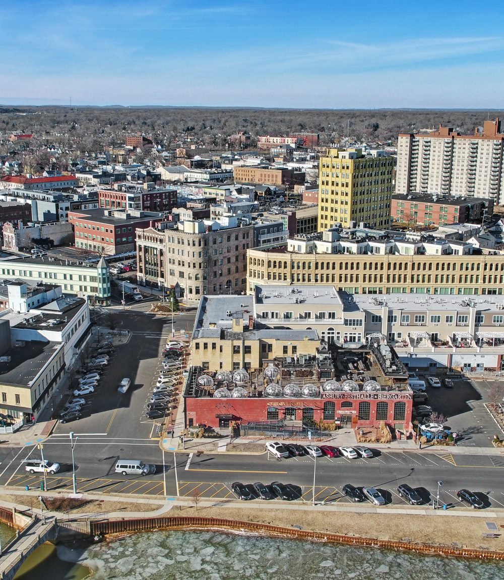 Aerial view of downtown Asbury Park, with the Asbury Festhalle and surrounding buildings by the waterfront.