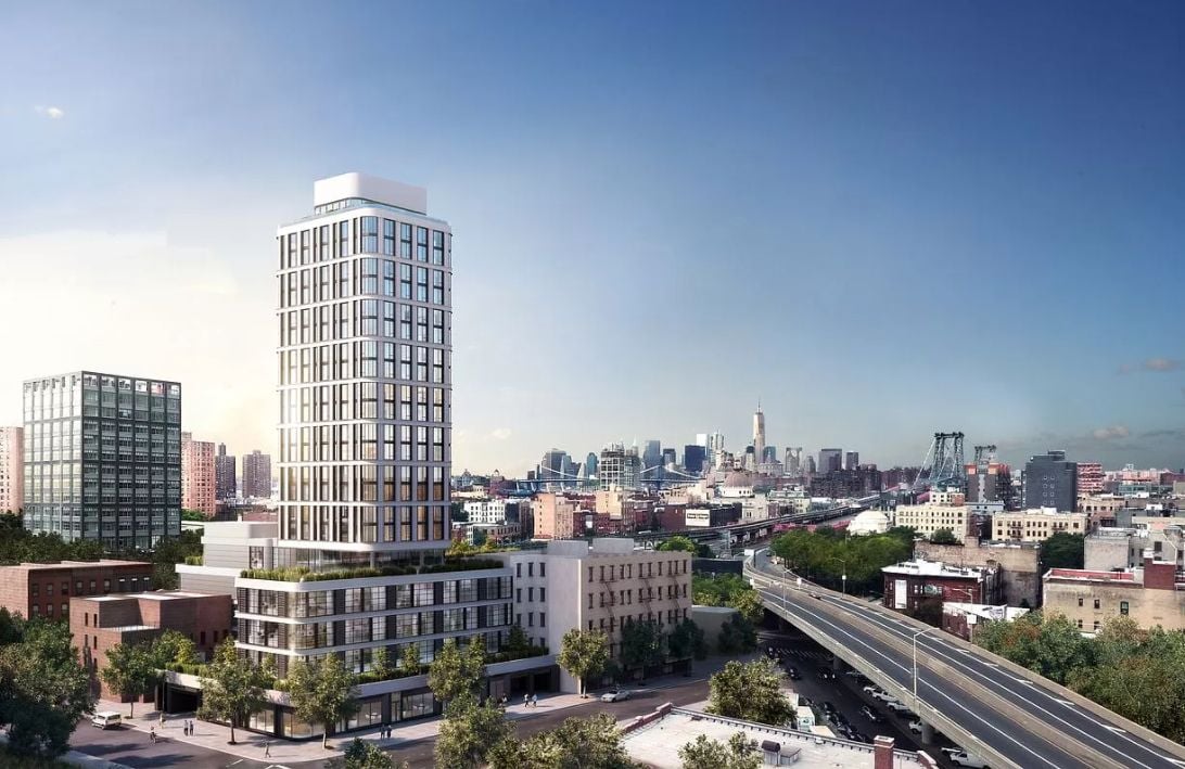 Modern condominium tower overlooking a city skyline, with a suspension bridge and elevated highway nearby.