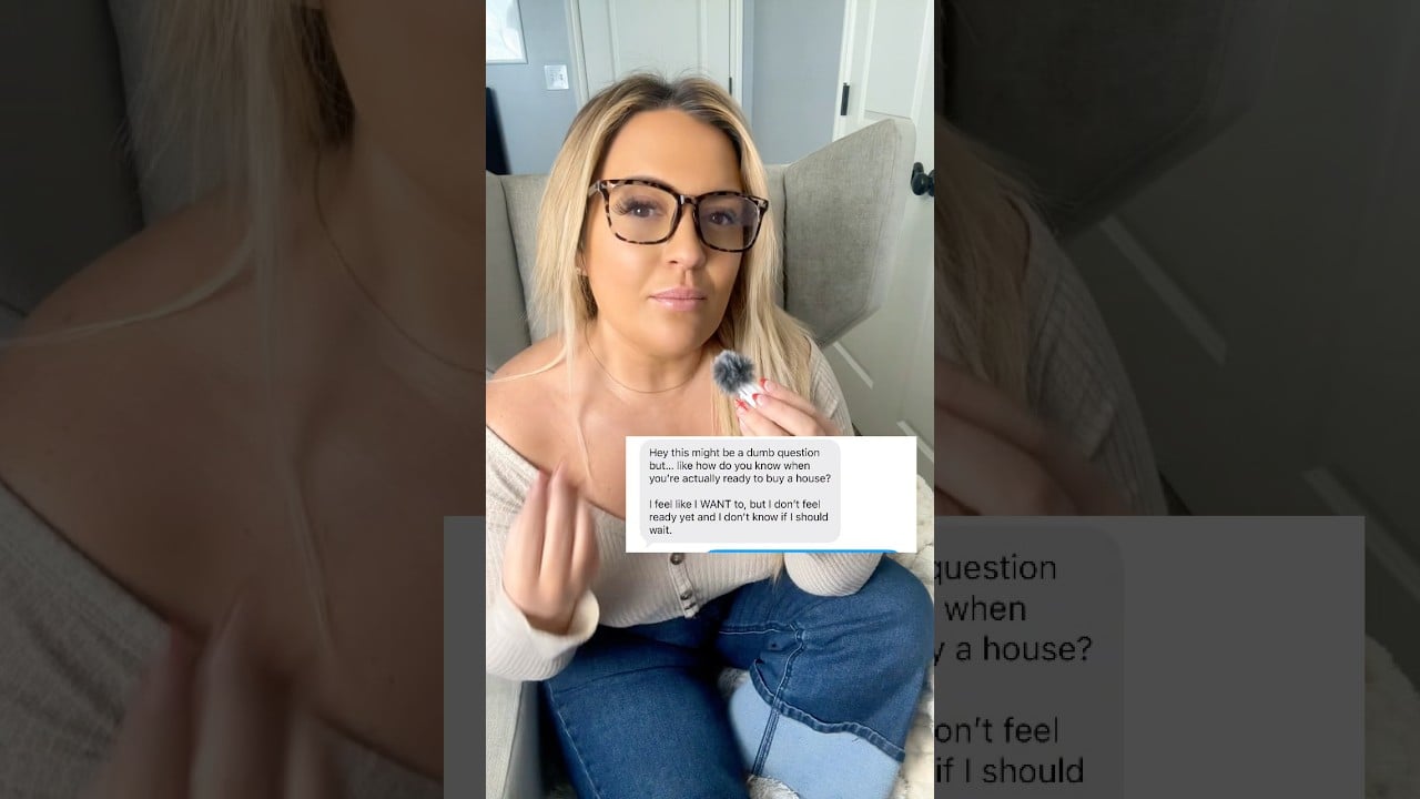 Woman in glasses holds a microphone while discussing when to buy a first home.
