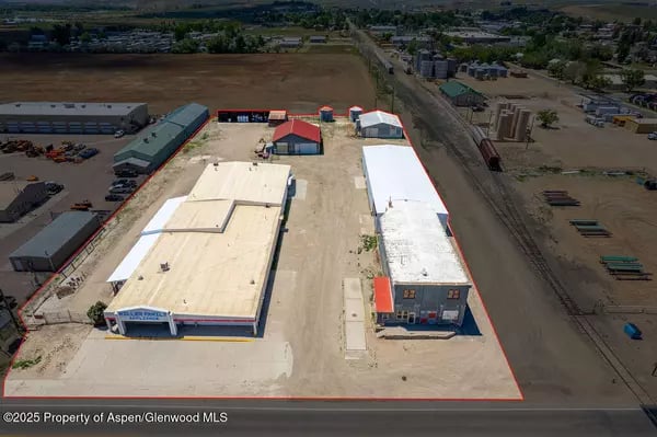 Aerial view of an industrial property with warehouse buildings and a red boundary outline.