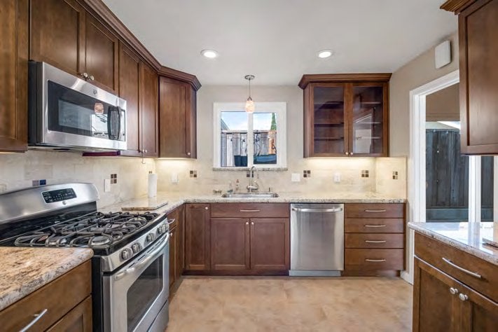 Kitchen with wood cabinets and stainless appliances at 1401 and 1403 Cary Avenue, San Mateo
