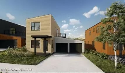 Modern tan two-story home with a double garage, broad driveway, and low landscaping.