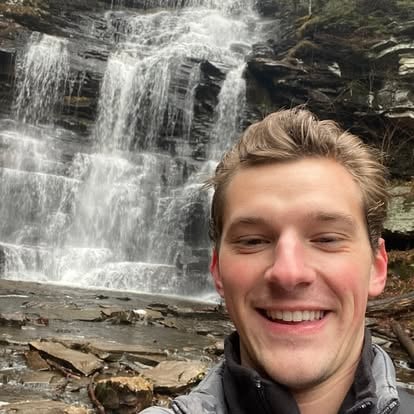 Aaron hiking near a waterfall