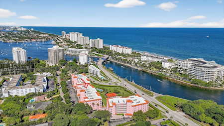 Aerial view of East Boca Raton with coastal high-rises, waterfront homes, and the Atlantic Ocean.