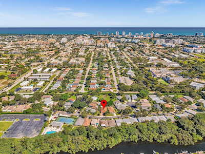 Aerial view of East Boca neighborhoods, with a red location marker, waterways, and the ocean beyond.