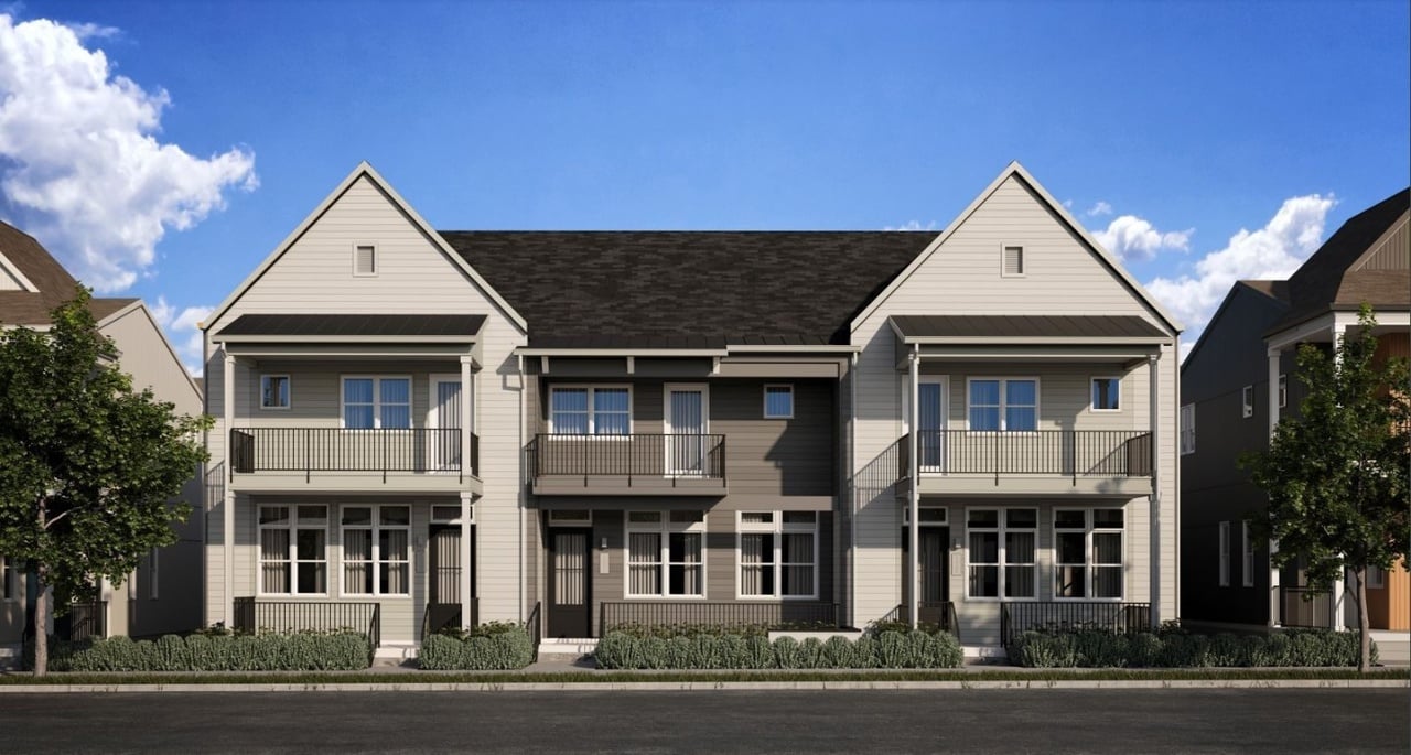 Row of attached two-story homes with upper balconies and landscaped front porches.