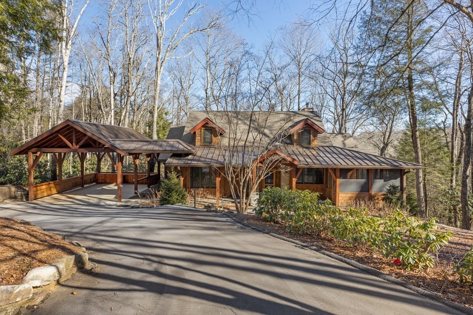 Craftsman-style mountain home with stone and timber accents among the trees at 451 Crescent Trail in Cullasaja Club, Highlands NC