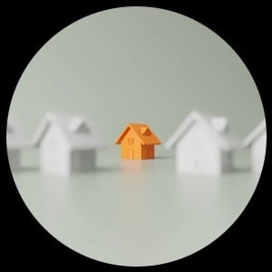 Orange model house among white model houses.