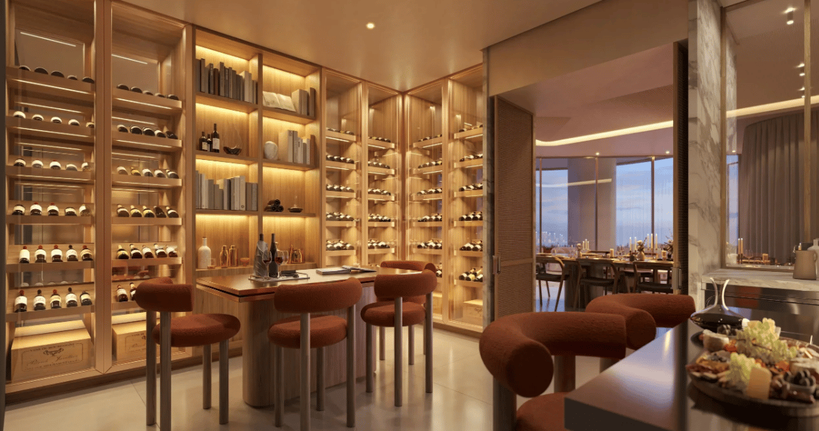 Luxury wine room with illuminated wine shelves, a tasting island, and an adjoining dining room.