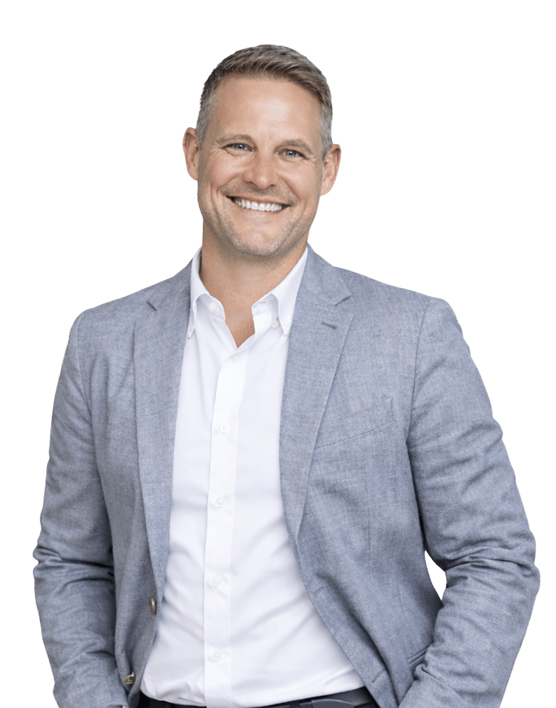 Smiling man in a light gray blazer and white shirt.