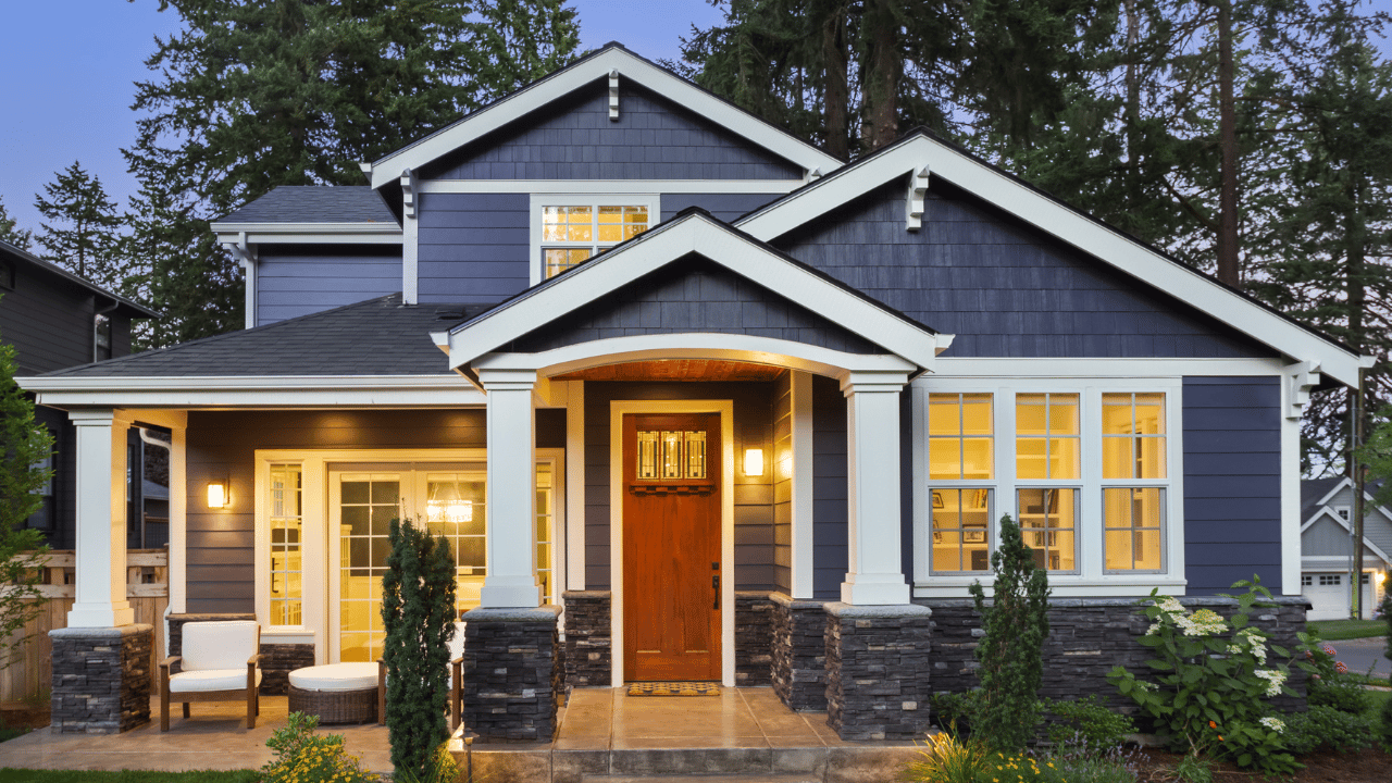 blue house with interior lights on for a glowing sunset photo