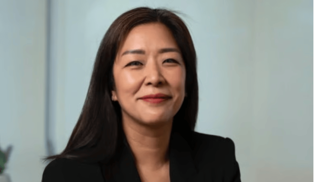 Woman with long dark hair wearing a black blazer