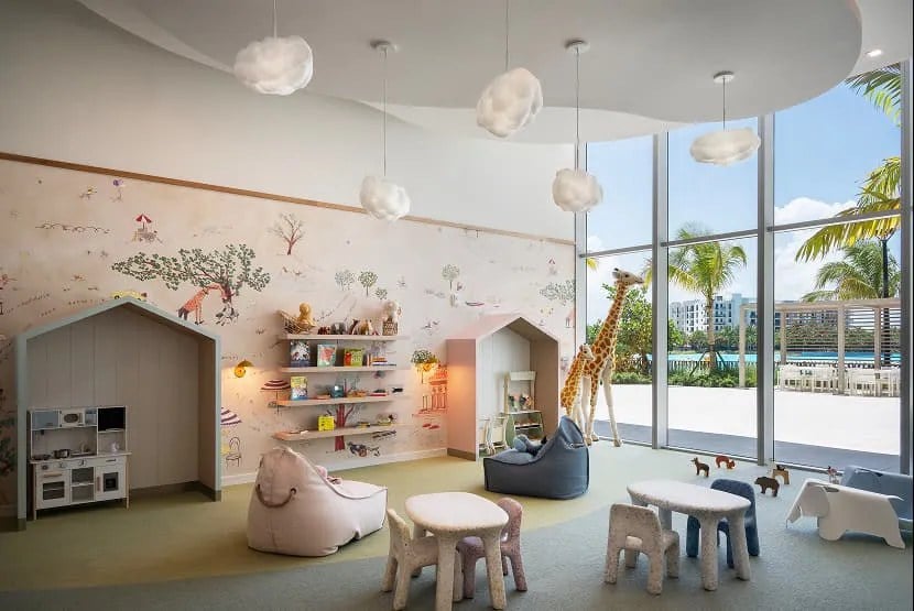 ONE Park Tower children’s playroom with indoor play areas and pool-facing windows.