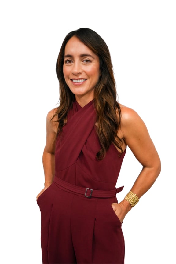 Lara K Toro in a burgundy sleeveless outfit with a gold bracelet.