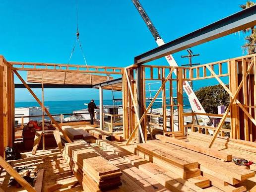 Real estate agent with construction background inspecting the foundation and framing of a Newport Beach home before purchase