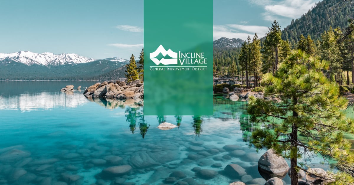 IVGID logo over Lake Tahoe with granite boulders, pines, and snowy Sierra peaks at Incline Village.