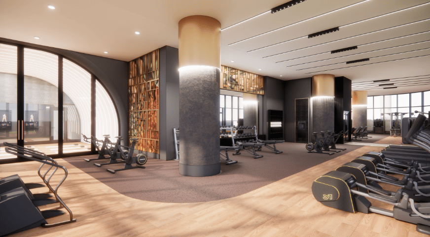 Gym with rows of exercise equipment, warm wood flooring, and large windows.