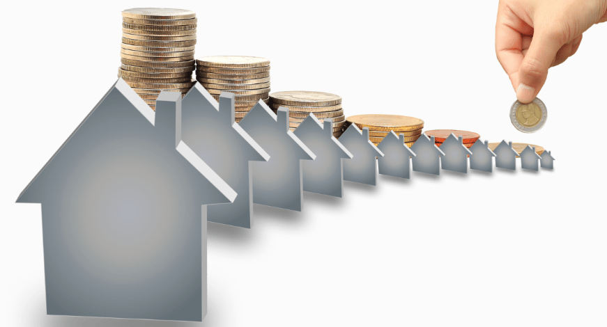 A hand holds a coin over shrinking house shapes and diminishing stacks of coins.