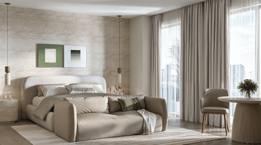 Bright staged bedroom with a bed, sofa, floor-to-ceiling curtains, and city views.