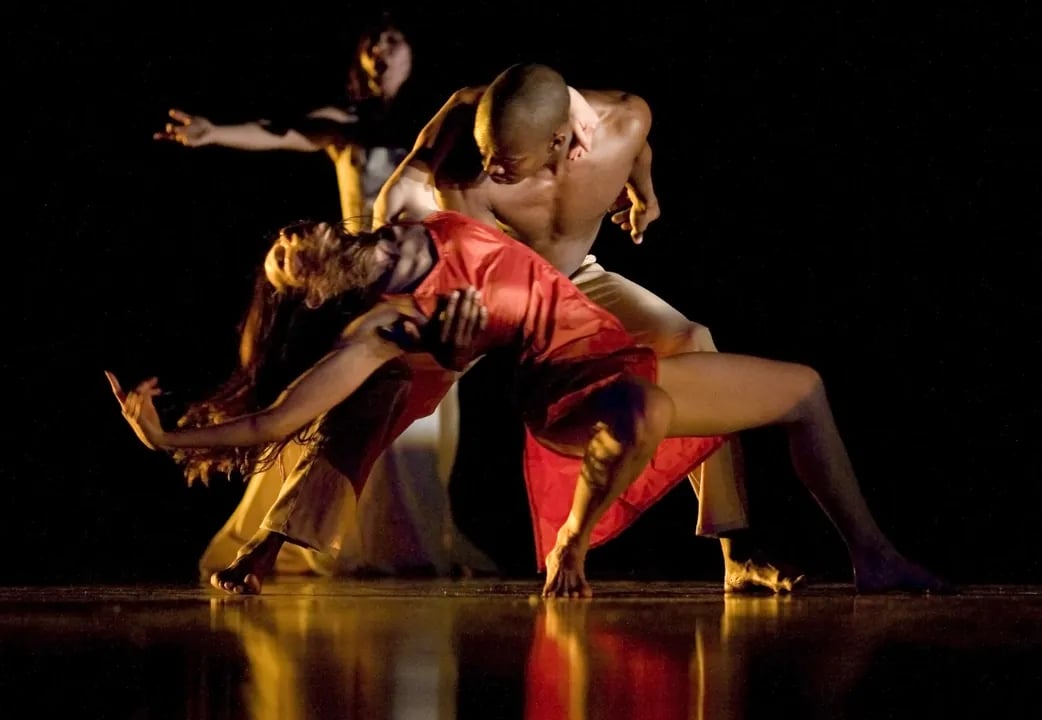 KUNST-STOFF dancers performing a contemporary routine at YBCA, with a male dancer dipping a partner in a red dress.
