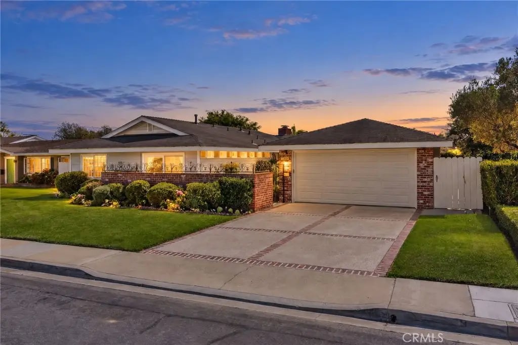 Front exterior of a single-story traditional home with private courtyard in Irvine Terrace, Corona del Mar