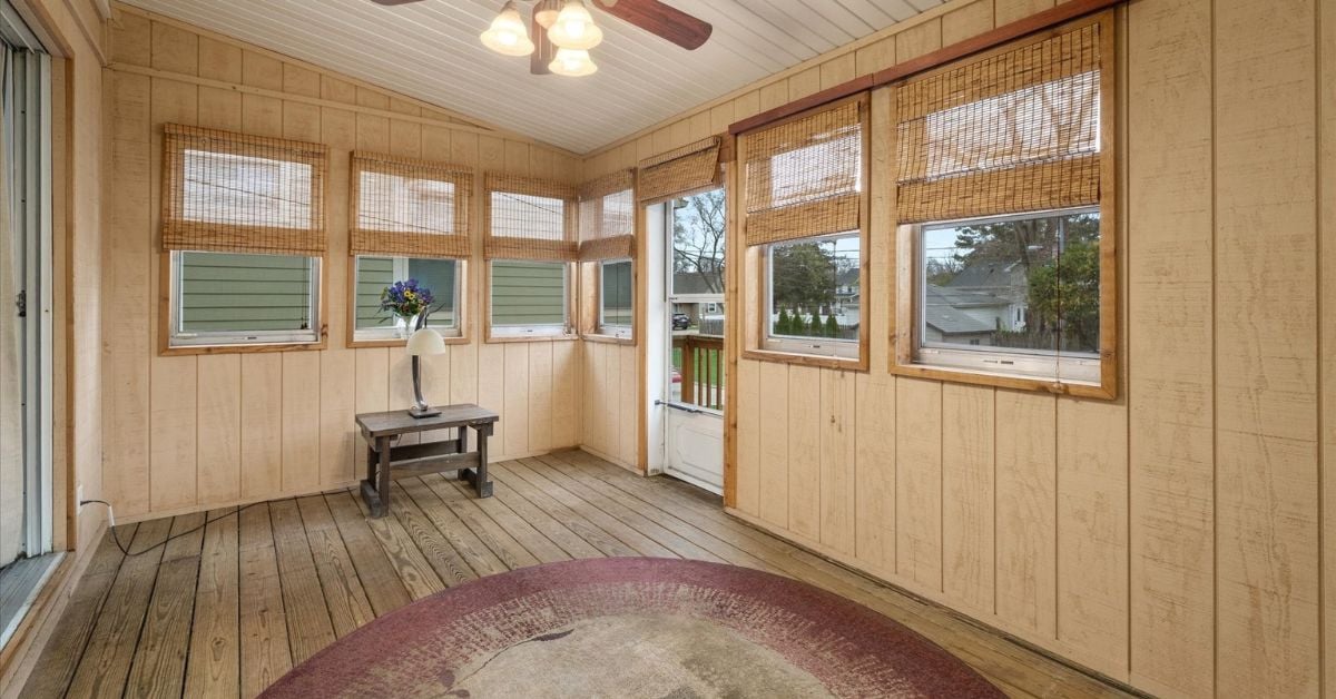 Screened in porch with wood paneling and ceiling fan at 4217 Elm St Downers Grove IL 60515 listed by the Tully Team