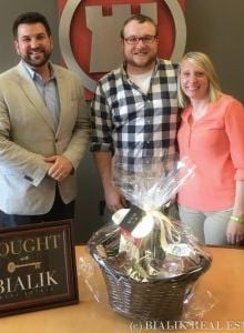 Colin and Ashley celebrate closing day with their real estate agent.