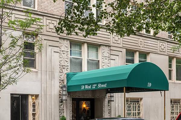 Building entrance at 59 West 12th Street beneath a green awning on a decorated stone facade.