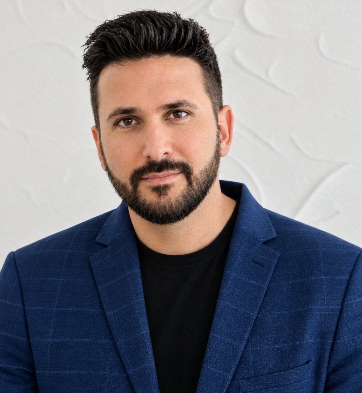 Michael Rigillo, a bearded man in a navy blazer and black shirt.