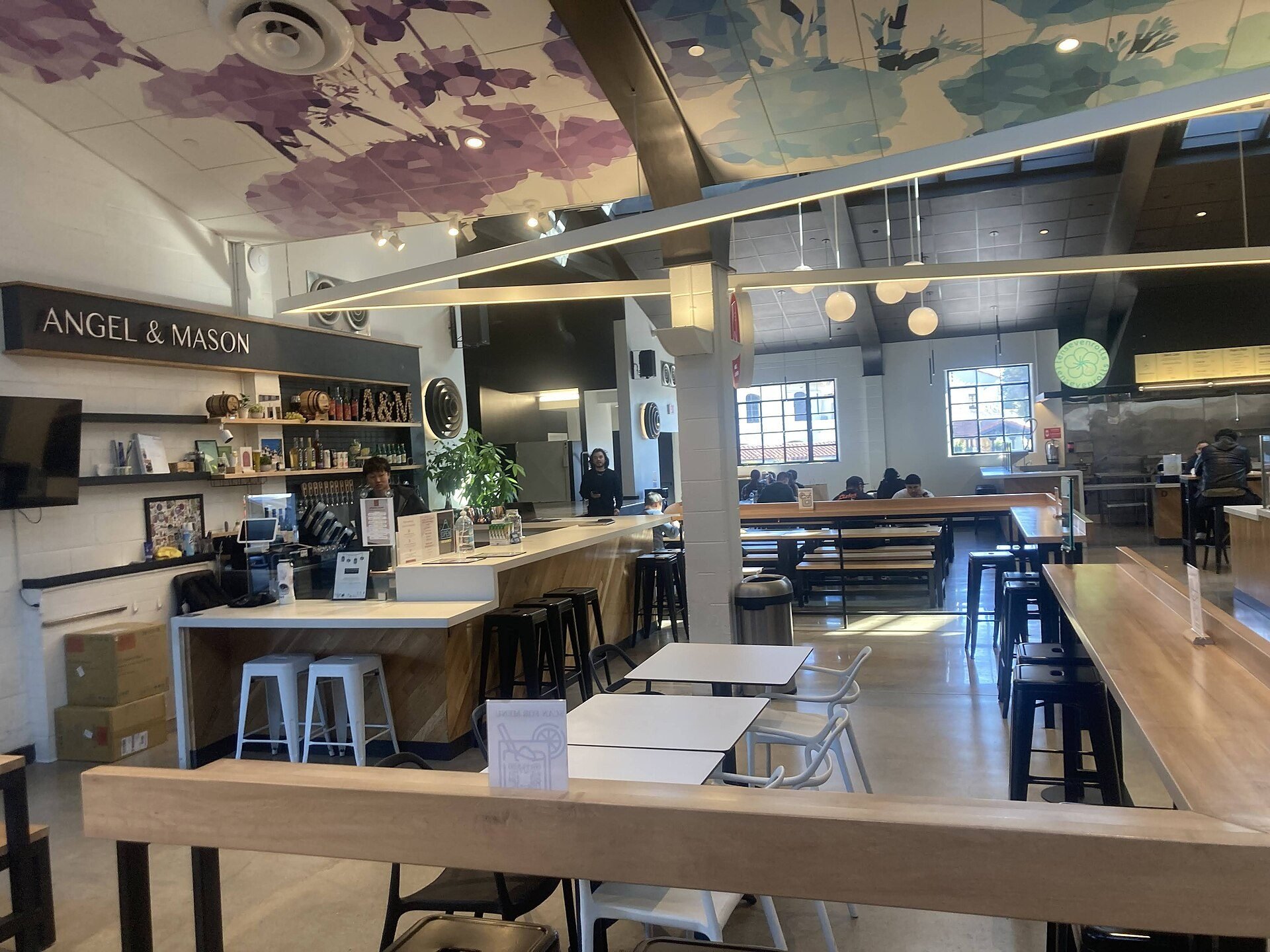 Interior tables and food counters at Blossom Market Hall in San Gabriel, photographed January 2023