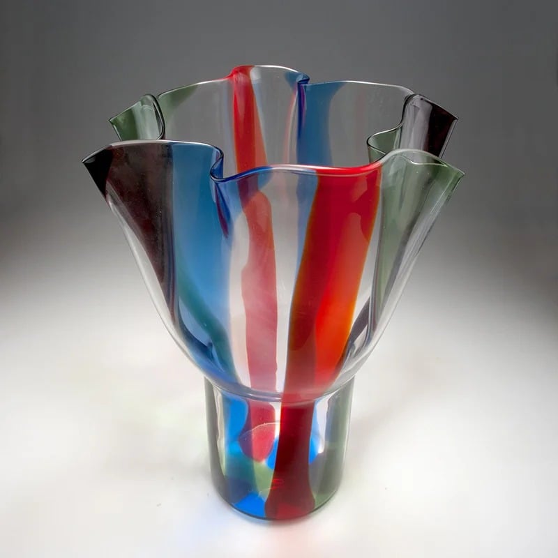 Sculptural multicolored glass vase with a flared, wavy rim.